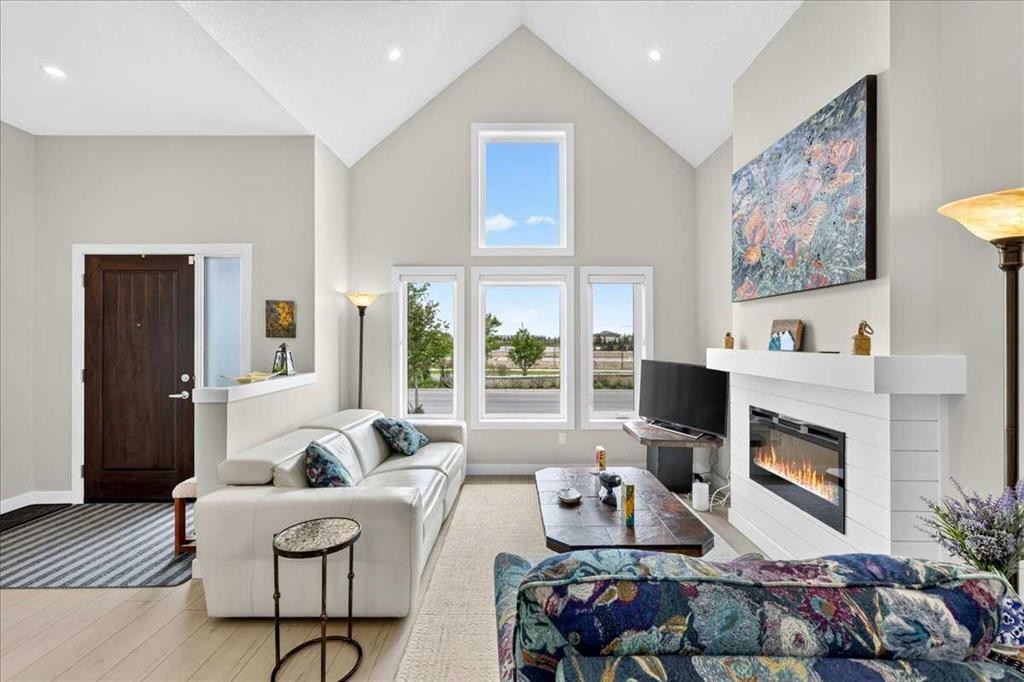 1066 Creekside Boulevard Sw, Calgary, AB - Indoor Photo Showing Living Room With Fireplace