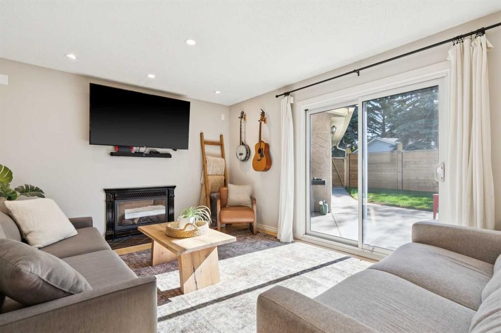16 Brenner Place Nw, Calgary, AB - Indoor Photo Showing Living Room With Fireplace