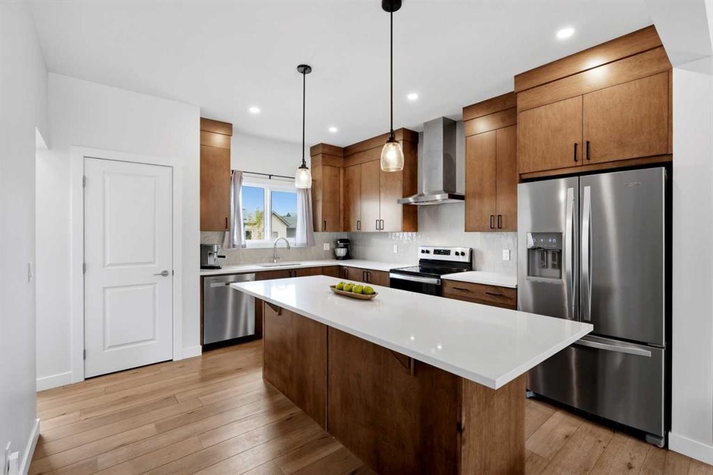 52 Emberside Grove, Cochrane, AB - Indoor Photo Showing Kitchen With Stainless Steel Kitchen With Upgraded Kitchen