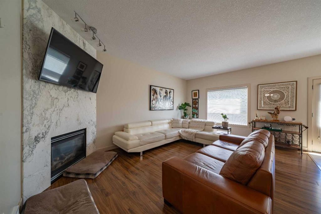 144 Everhollow Street Sw, Calgary, AB - Indoor Photo Showing Living Room With Fireplace