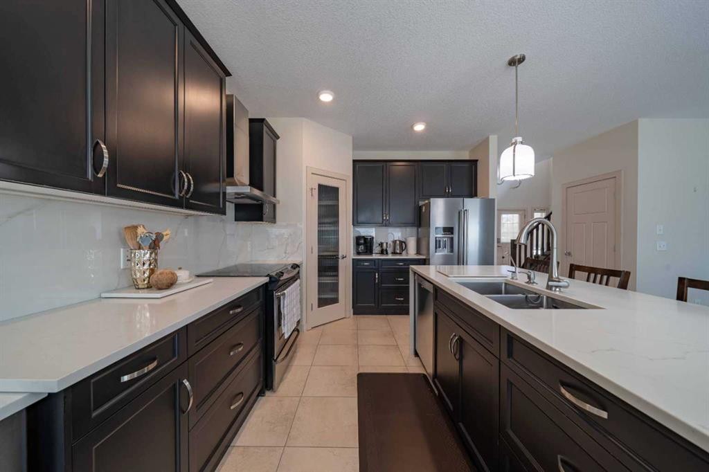 144 Everhollow Street Sw, Calgary, AB - Indoor Photo Showing Kitchen With Double Sink With Upgraded Kitchen