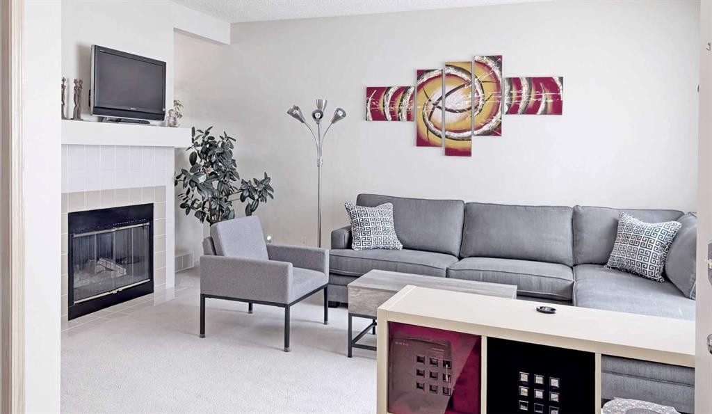 12 Shawbrooke Court Sw, Calgary, AB - Indoor Photo Showing Living Room With Fireplace