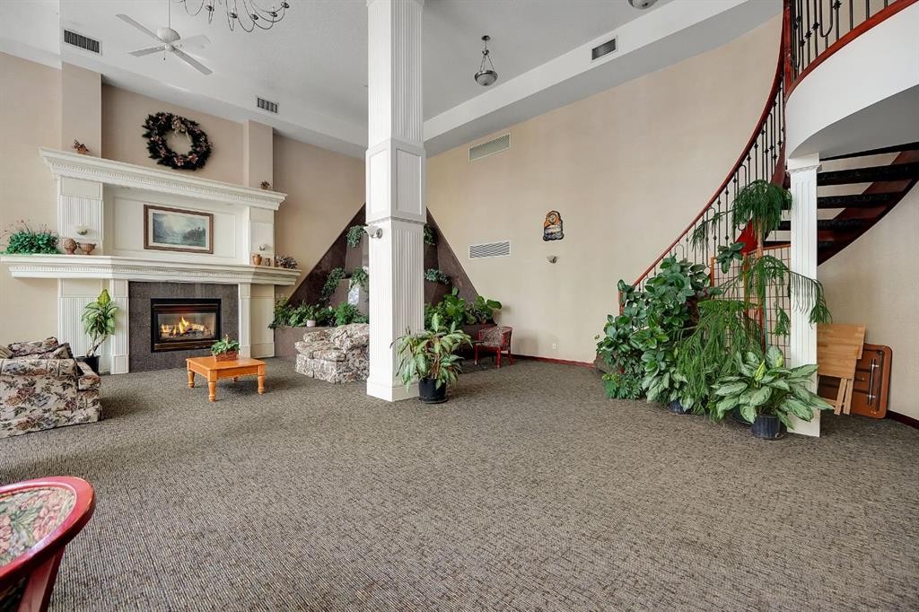227-1920 14 Avenue Ne, Calgary, AB - Indoor Photo Showing Other Room With Fireplace