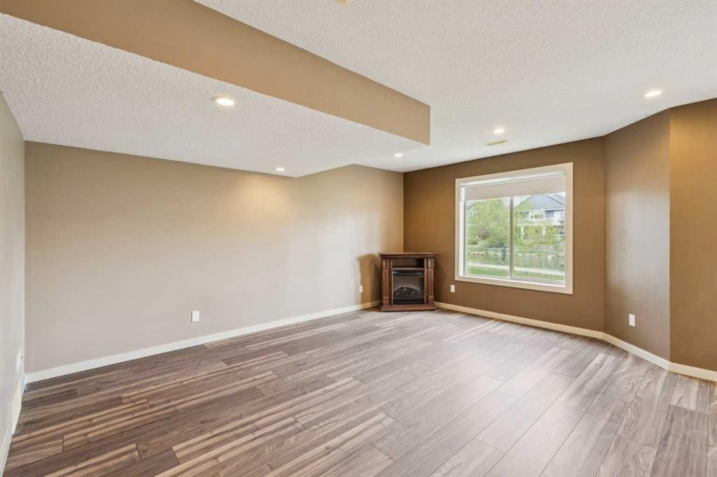 212 Bayside Point Sw, Airdrie, AB - Indoor With Fireplace