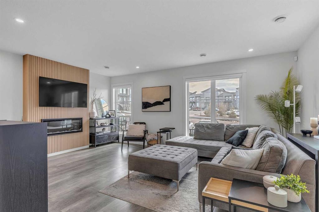 302-260 Rowley Way Nw, Calgary, AB - Indoor Photo Showing Living Room With Fireplace