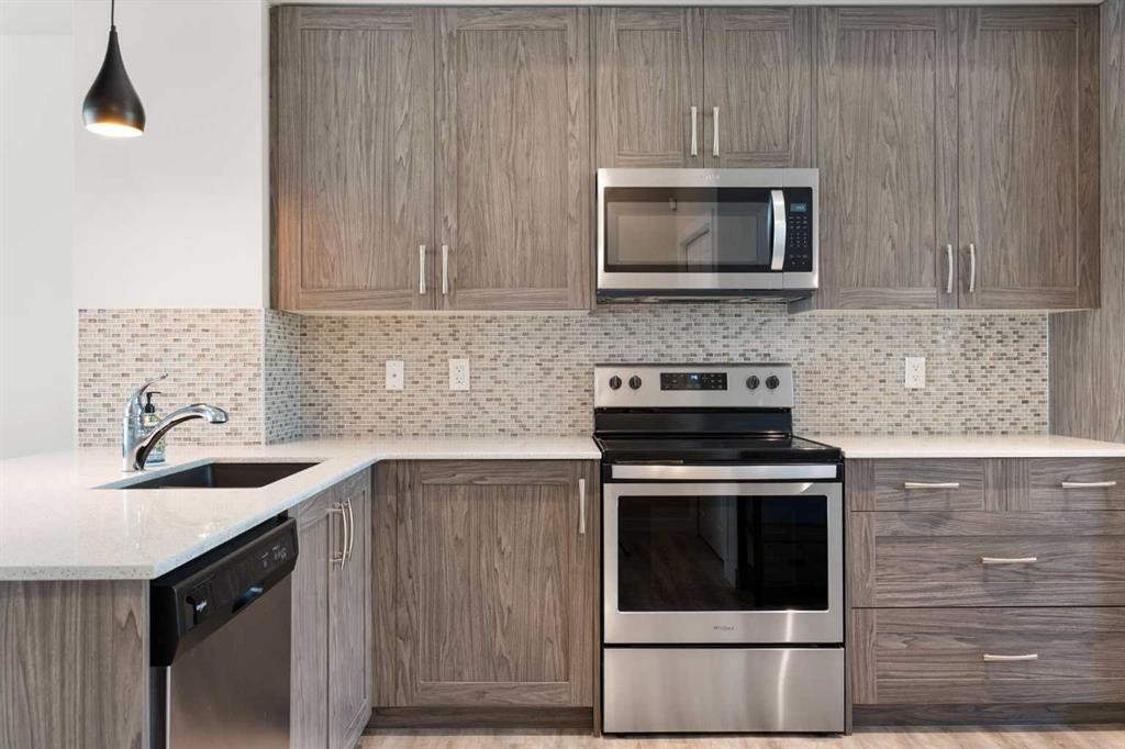 28-138 Seton Passage Se, Calgary, AB - Indoor Photo Showing Kitchen With Stainless Steel Kitchen With Upgraded Kitchen