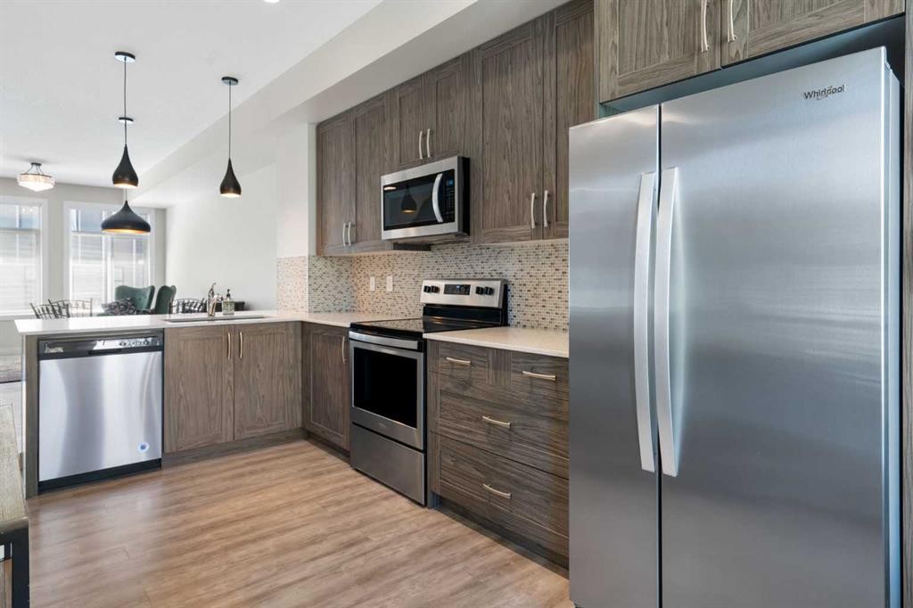 28-138 Seton Passage Se, Calgary, AB - Indoor Photo Showing Kitchen With Stainless Steel Kitchen With Upgraded Kitchen