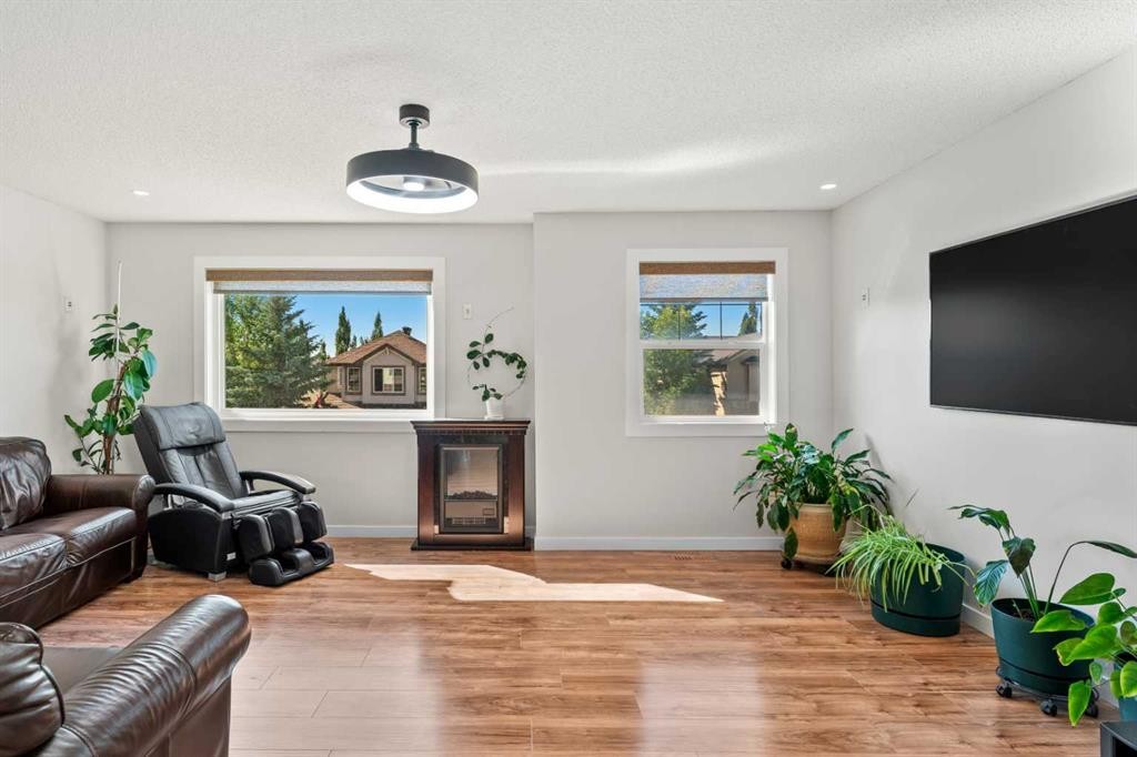 114 Chapalina Terrace Se, Calgary, AB - Indoor Photo Showing Living Room With Fireplace