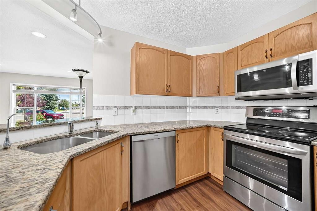 43 Somerside Common Sw, Calgary, AB - Indoor Photo Showing Kitchen With Stainless Steel Kitchen With Double Sink