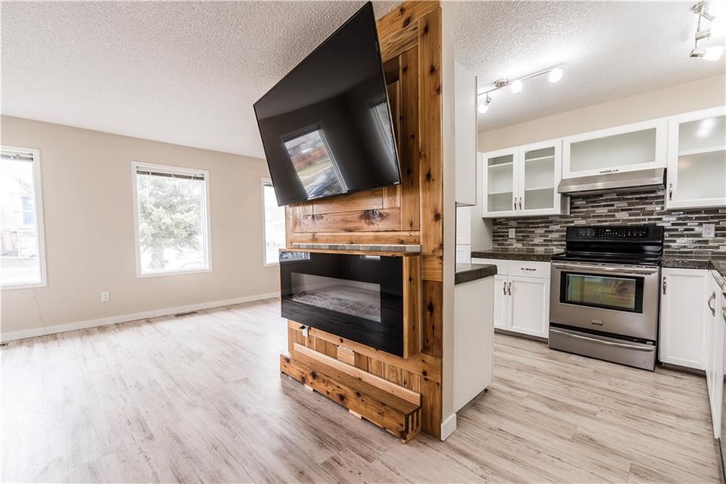 1019 Smith Avenue, Crossfield, AB - Indoor Photo Showing Kitchen With Fireplace
