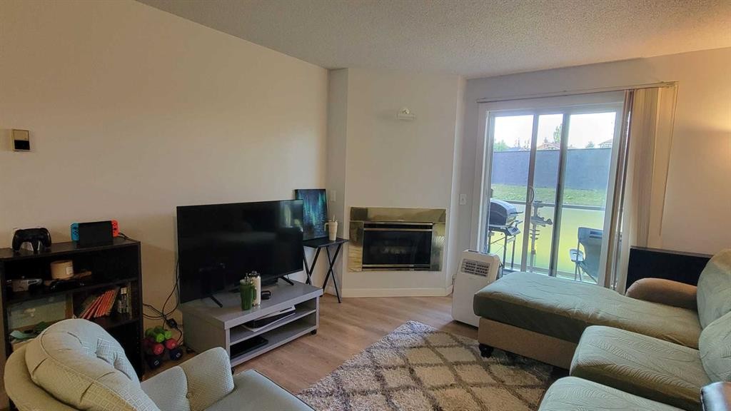 13-2000 Edenwold Heights Nw, Calgary, AB - Indoor Photo Showing Living Room With Fireplace