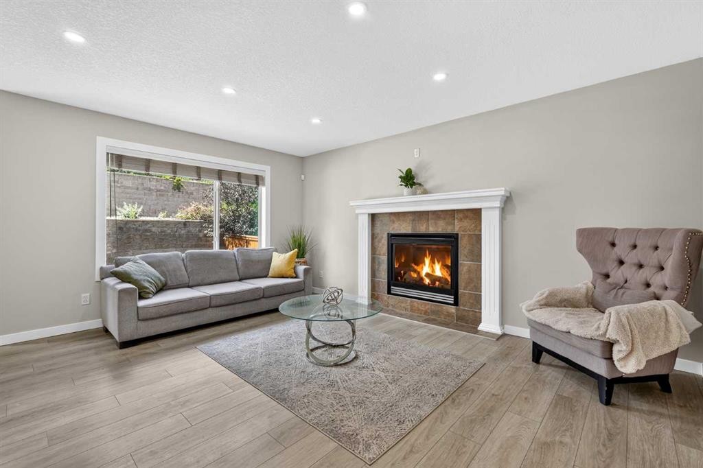 261 Panamount Hill Nw, Calgary, AB - Indoor Photo Showing Living Room With Fireplace