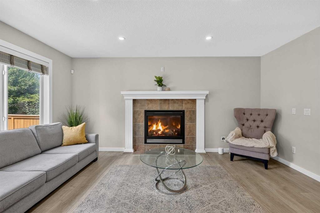 261 Panamount Hill Nw, Calgary, AB - Indoor Photo Showing Living Room With Fireplace