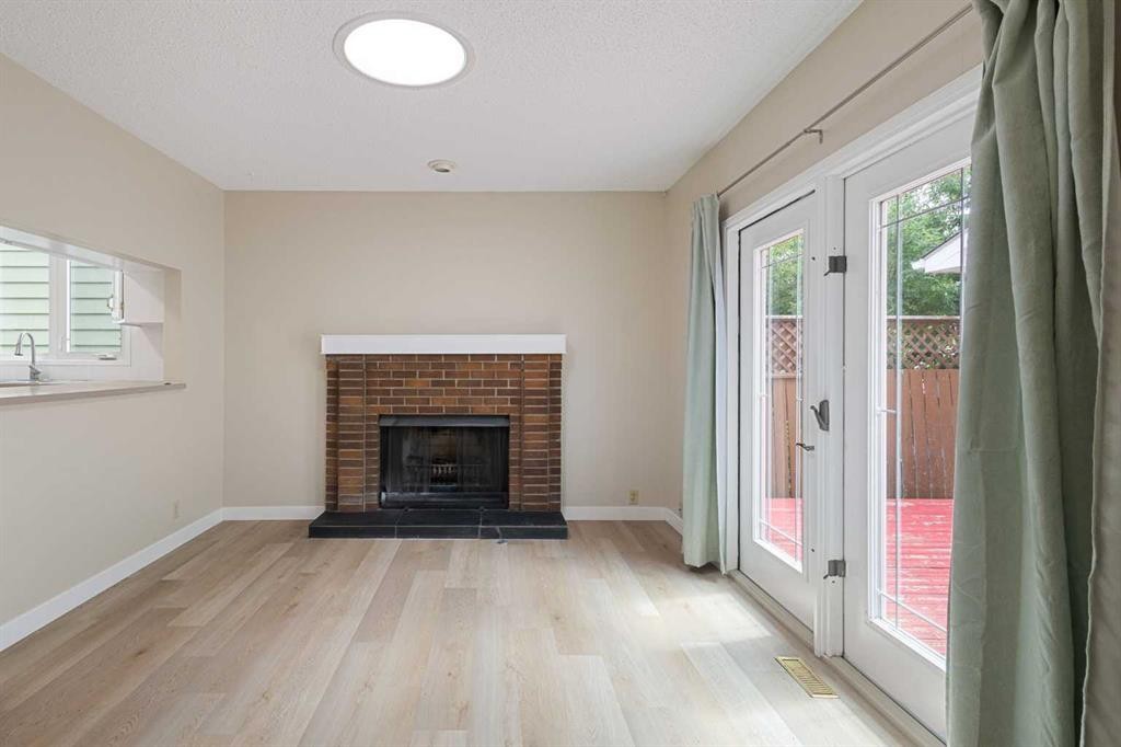 1111 Berkley Drive Nw, Calgary, AB - Indoor Photo Showing Living Room With Fireplace