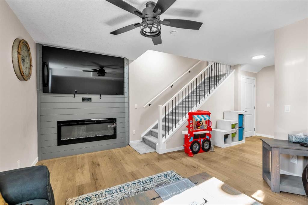 7 Emberside Park, Cochrane, AB - Indoor Photo Showing Other Room With Fireplace