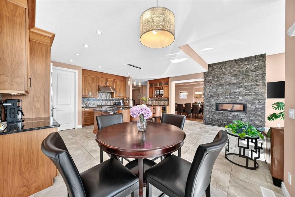 116 Panatella Rise Nw, Calgary, AB - Indoor Photo Showing Dining Room With Fireplace