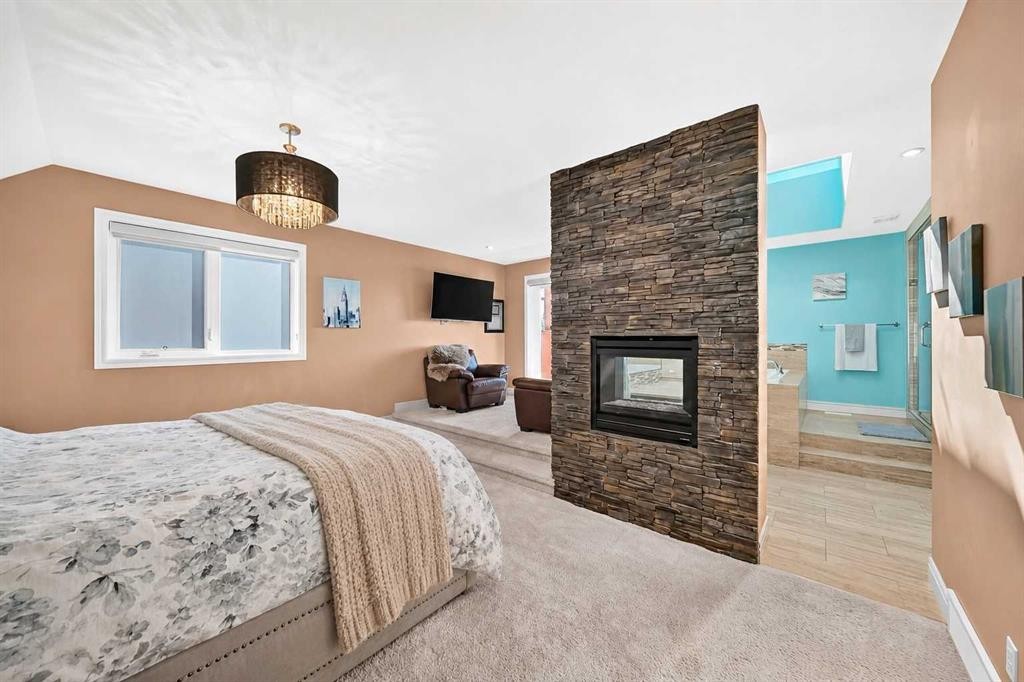 116 Panatella Rise Nw, Calgary, AB - Indoor Photo Showing Bedroom With Fireplace