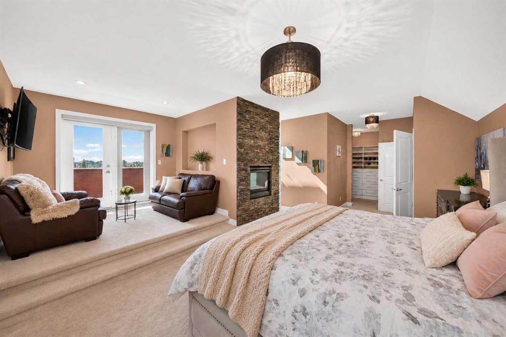 116 Panatella Rise Nw, Calgary, AB - Indoor Photo Showing Bedroom With Fireplace