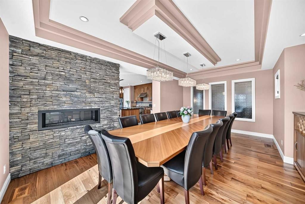 116 Panatella Rise Nw, Calgary, AB - Indoor Photo Showing Dining Room With Fireplace