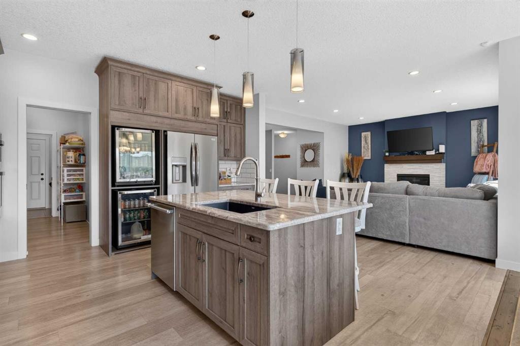 325 Bayside Crescent Sw, Airdrie, AB - Indoor Photo Showing Kitchen With Fireplace With Upgraded Kitchen