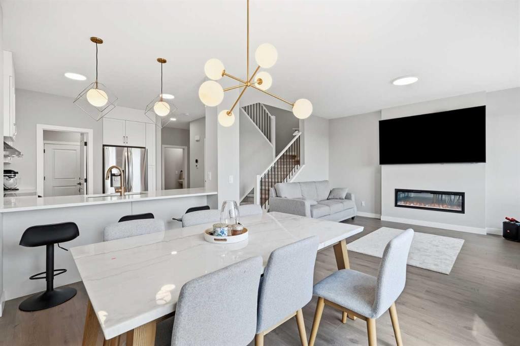 143 Belvedere Crescent Se, Calgary, AB - Indoor Photo Showing Dining Room With Fireplace