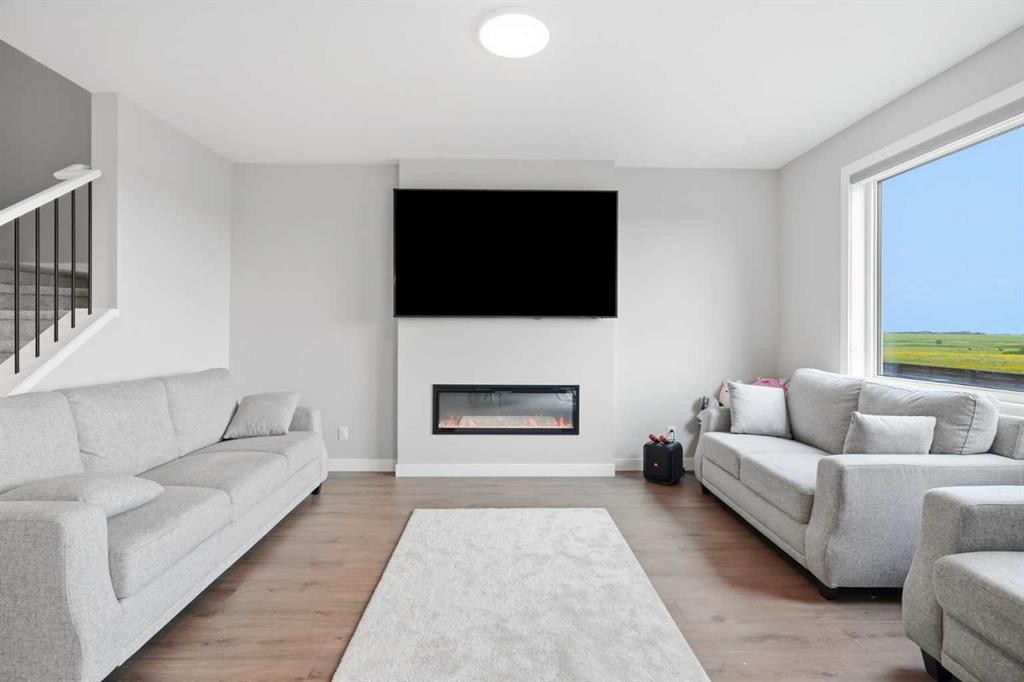 143 Belvedere Crescent Se, Calgary, AB - Indoor Photo Showing Living Room With Fireplace