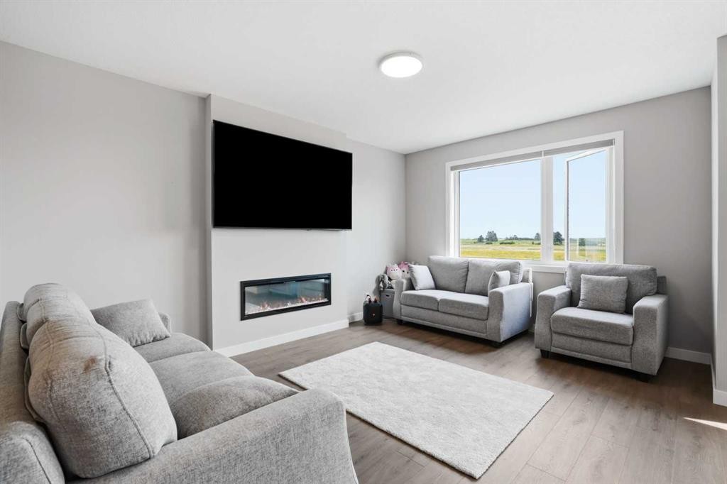 143 Belvedere Crescent Se, Calgary, AB - Indoor Photo Showing Living Room With Fireplace