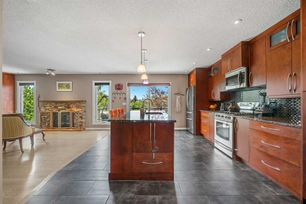34 Cascade Place, Cochrane, AB - Indoor Photo Showing Kitchen With Fireplace