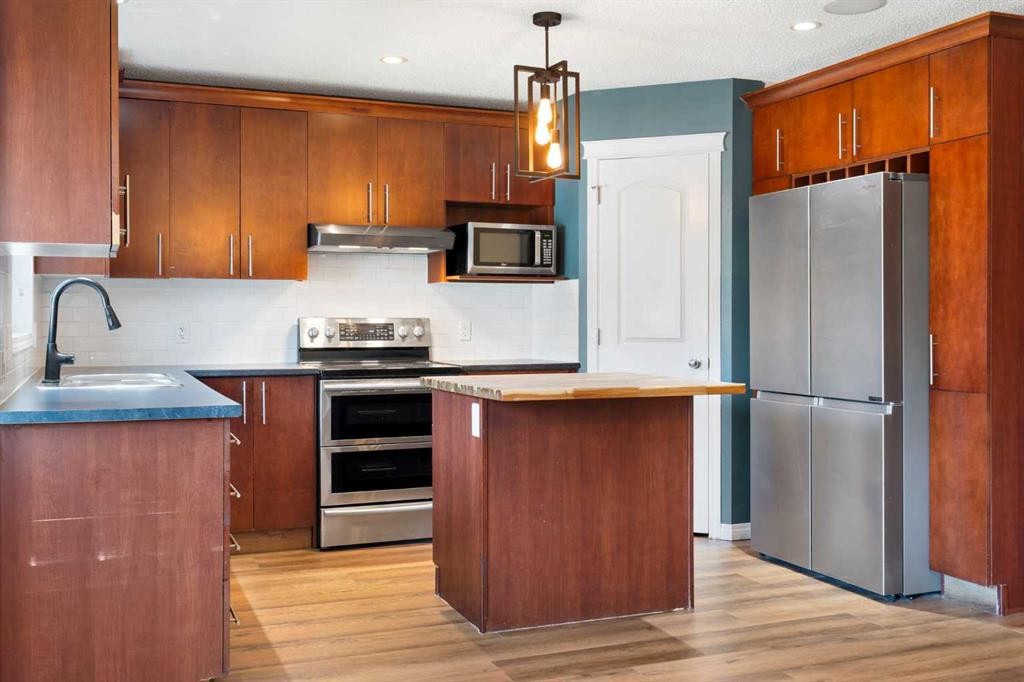 128 Silverado Way Sw, Calgary, AB - Indoor Photo Showing Kitchen With Double Sink