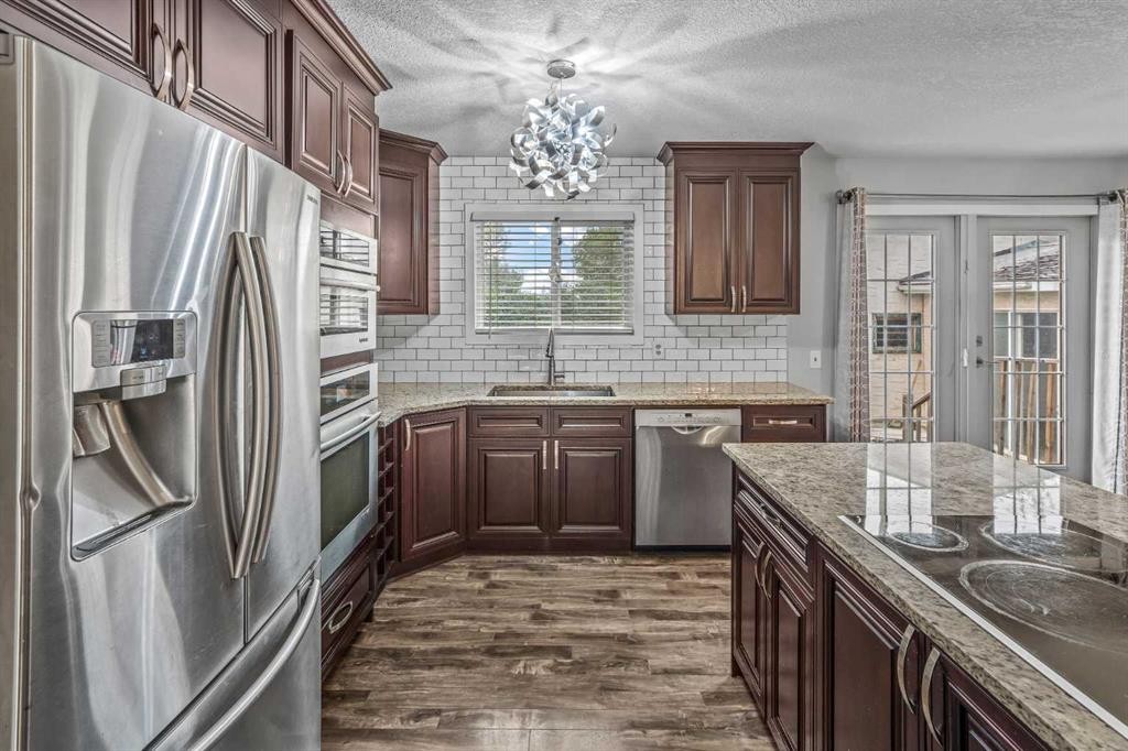 227 Manora Crescent Ne, Calgary, AB - Indoor Photo Showing Kitchen With Stainless Steel Kitchen With Upgraded Kitchen