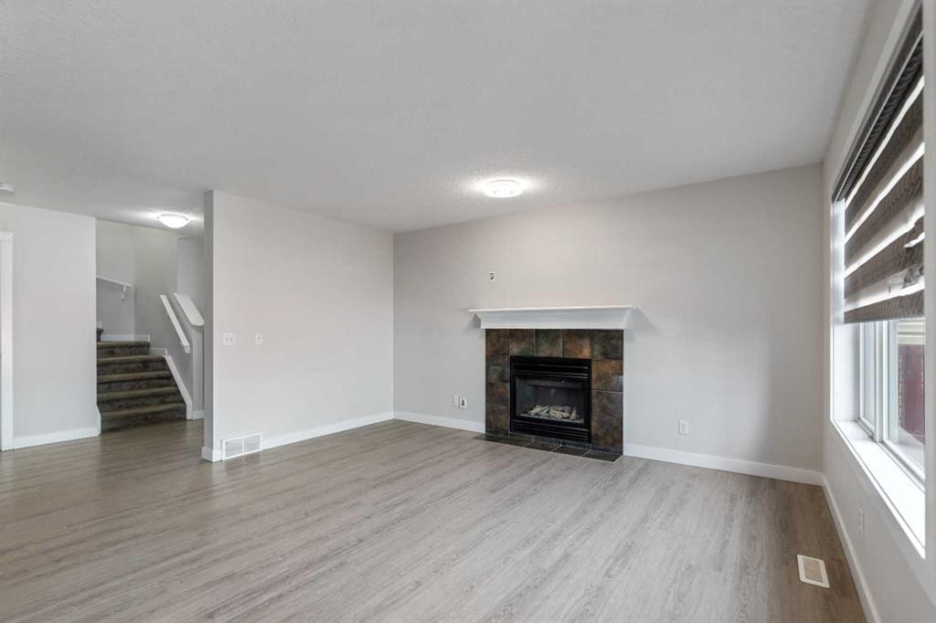 124 Saddlecrest Boulevard Ne, Calgary, AB - Indoor Photo Showing Living Room With Fireplace