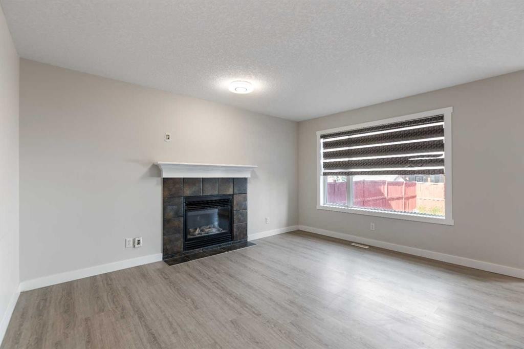 124 Saddlecrest Boulevard Ne, Calgary, AB - Indoor Photo Showing Living Room With Fireplace