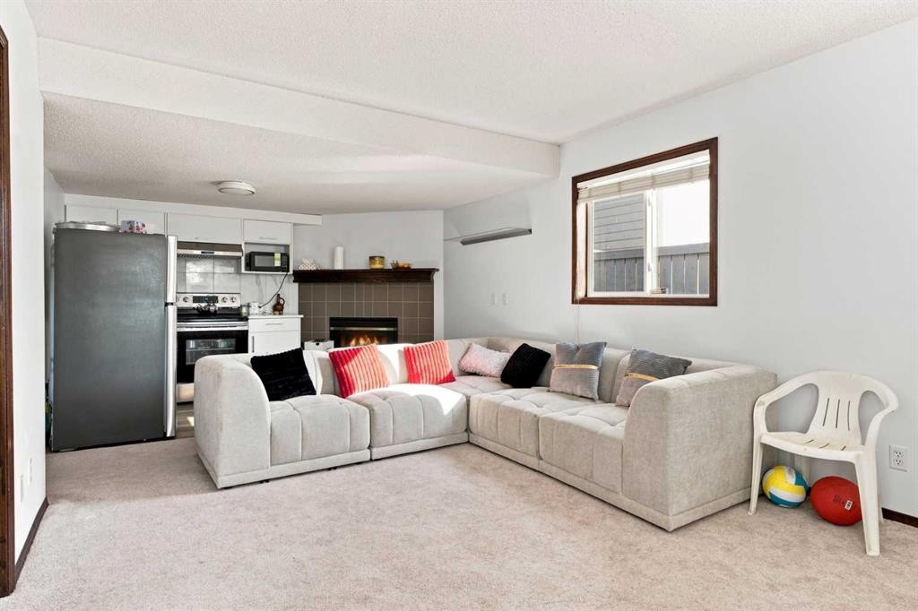 279 Coral Springs Circle Ne, Calgary, AB - Indoor Photo Showing Living Room With Fireplace