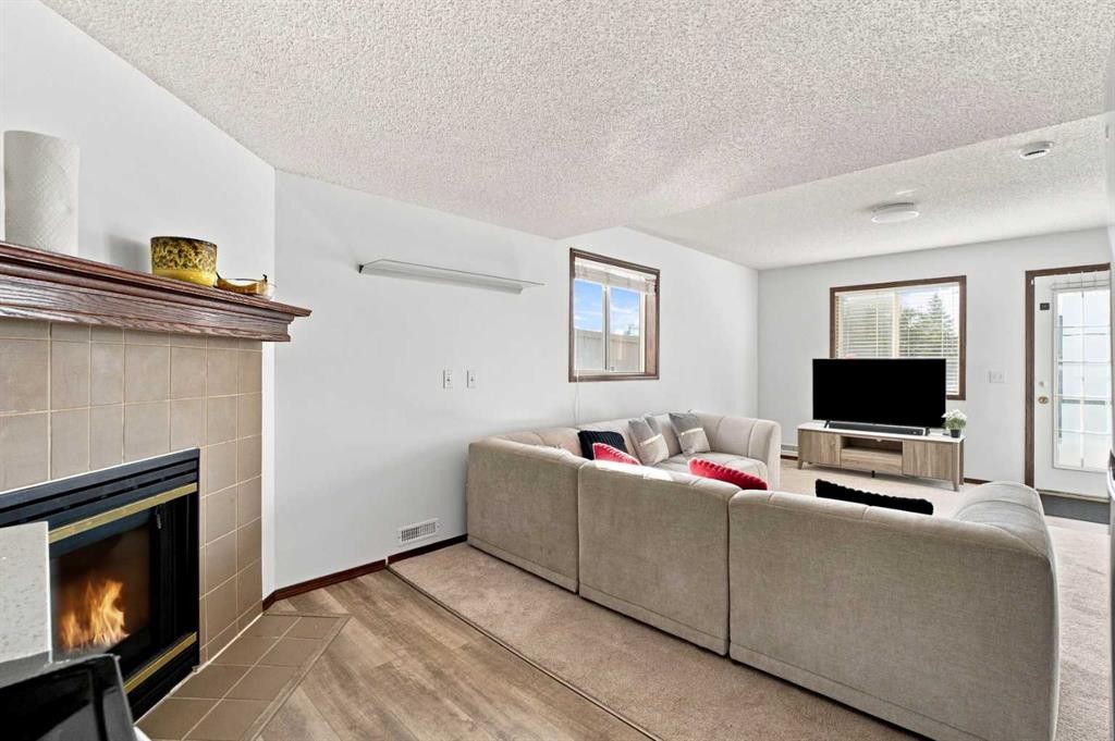 279 Coral Springs Circle Ne, Calgary, AB - Indoor Photo Showing Living Room With Fireplace