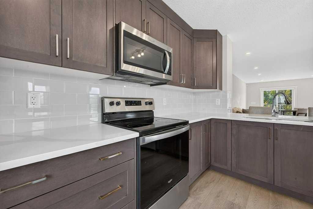 709-474 Seton Circle Se, Calgary, AB - Indoor Photo Showing Kitchen With Stainless Steel Kitchen With Double Sink With Upgraded Kitchen