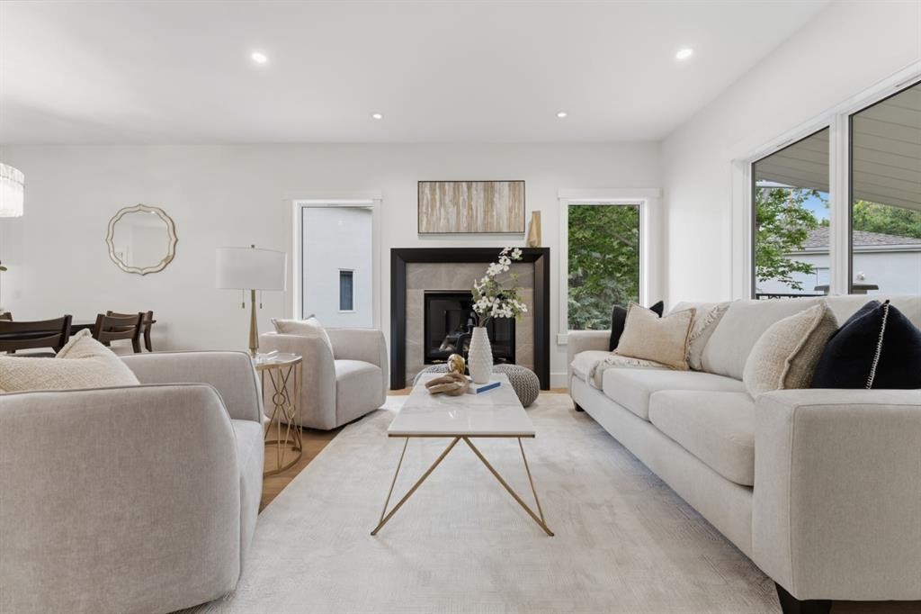 12 Prominence Point Sw, Calgary, AB - Indoor Photo Showing Living Room With Fireplace