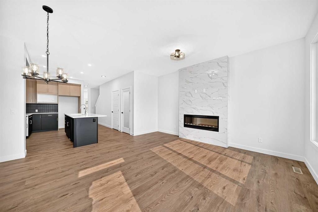 182 Lanark Gate Se, Airdrie, AB - Indoor Photo Showing Living Room With Fireplace