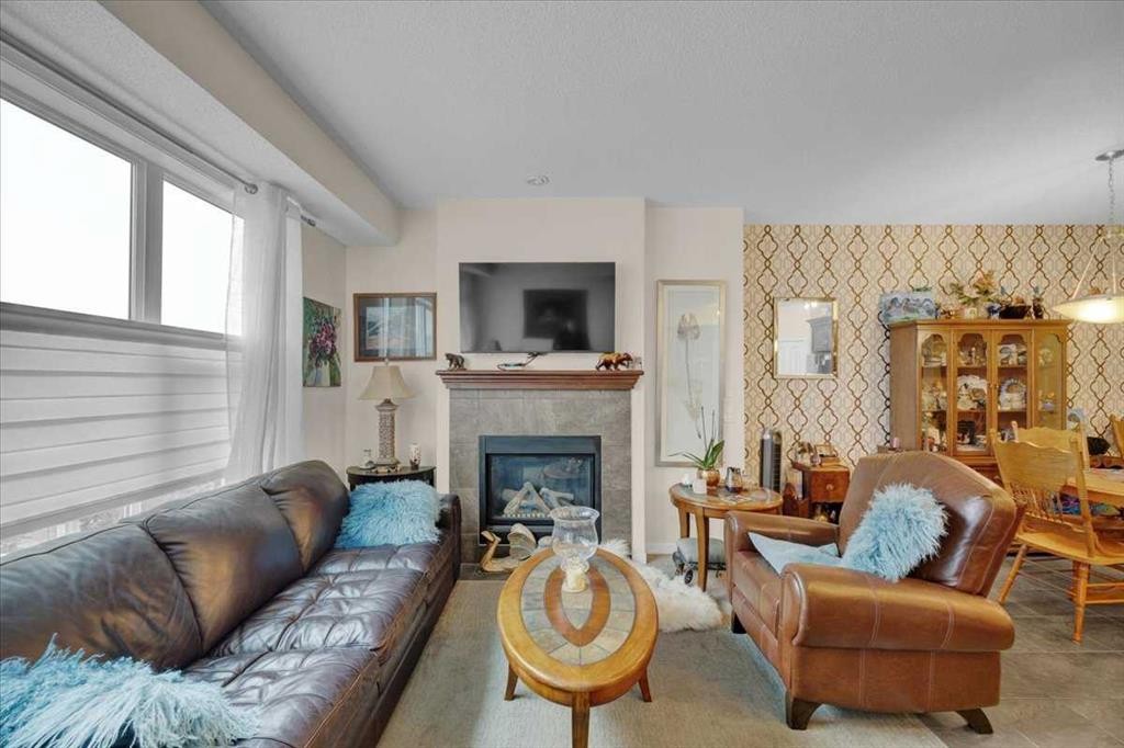226 Sunset Point, Cochrane, AB - Indoor Photo Showing Living Room With Fireplace