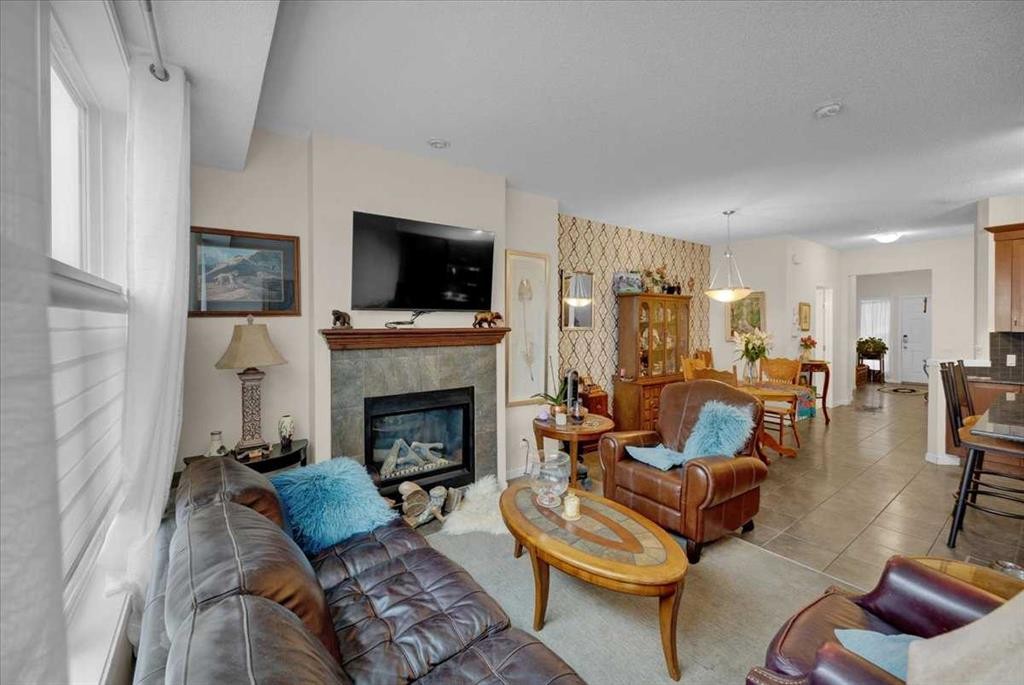 226 Sunset Point, Cochrane, AB - Indoor Photo Showing Living Room With Fireplace