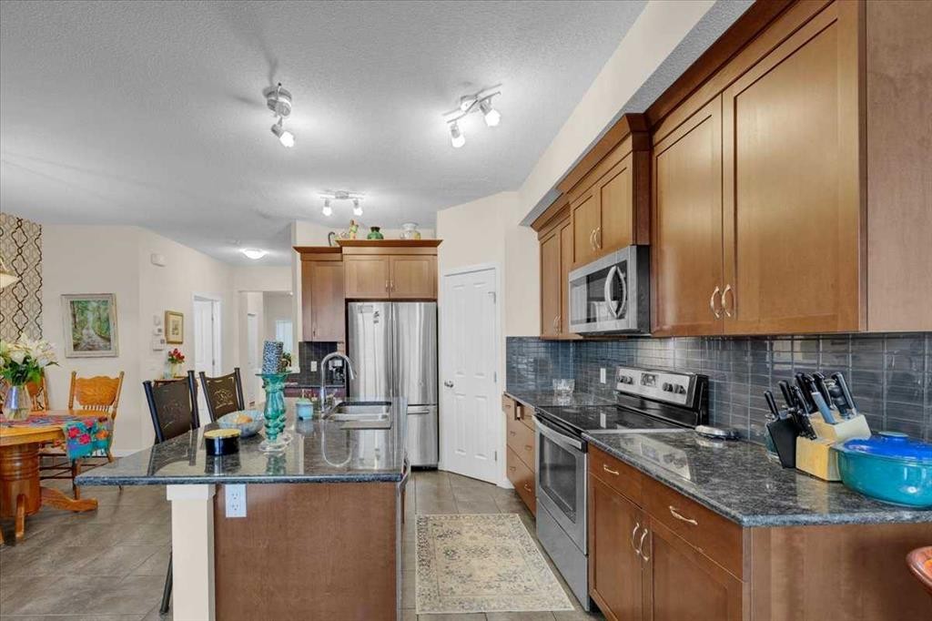 226 Sunset Point, Cochrane, AB - Indoor Photo Showing Kitchen With Double Sink With Upgraded Kitchen