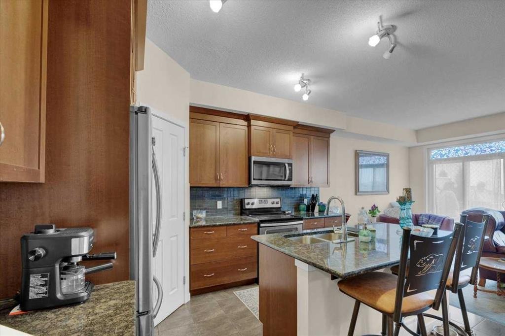 226 Sunset Point, Cochrane, AB - Indoor Photo Showing Kitchen With Double Sink