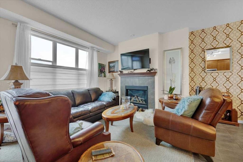 226 Sunset Point, Cochrane, AB - Indoor Photo Showing Living Room With Fireplace