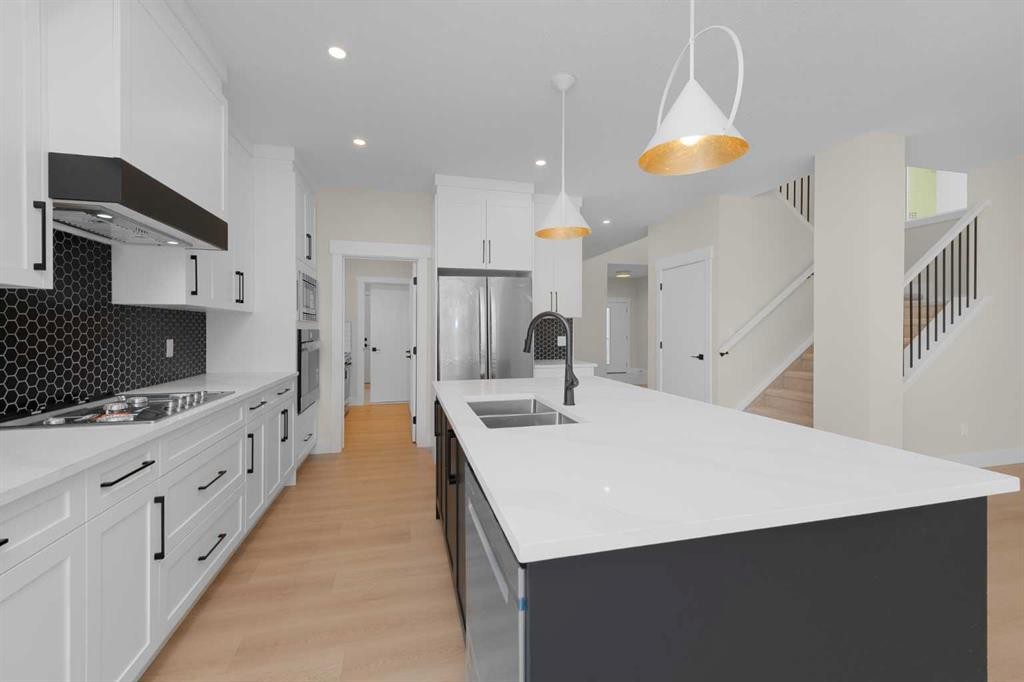 500 Rivercrest View, Cochrane, AB - Indoor Photo Showing Kitchen With Double Sink With Upgraded Kitchen