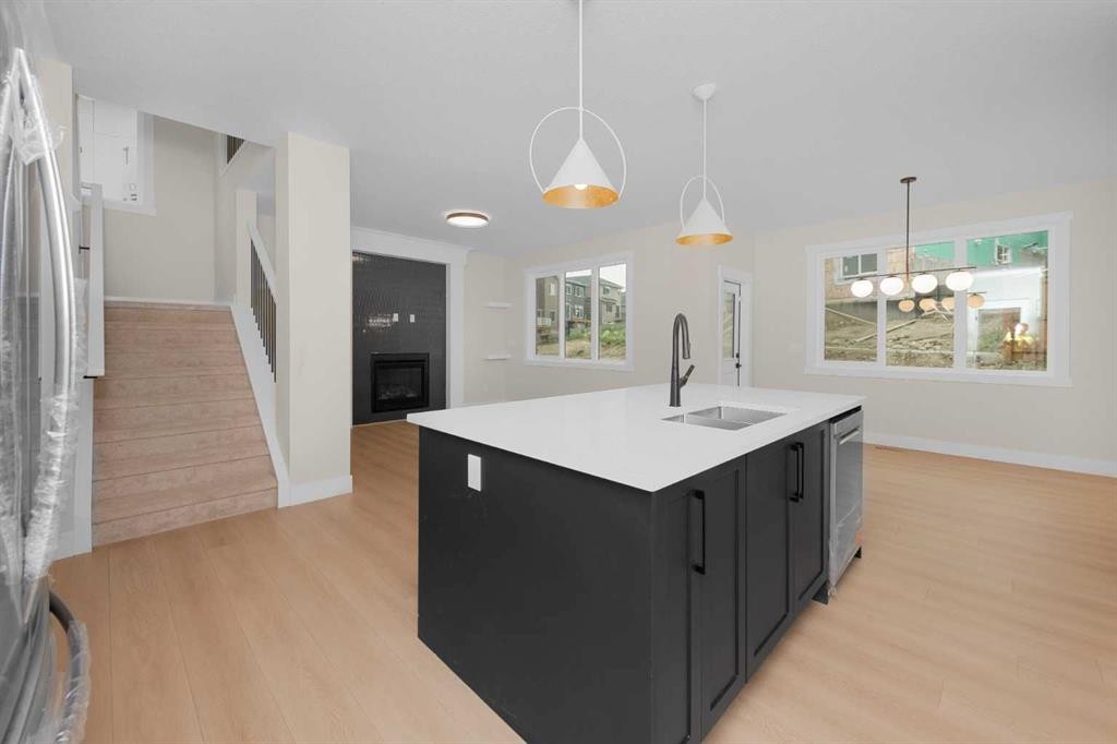 500 Rivercrest View, Cochrane, AB - Indoor Photo Showing Kitchen With Fireplace