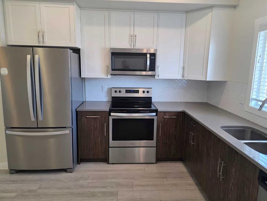107 Lucas Boulevard Nw, Calgary, AB - Indoor Photo Showing Kitchen With Stainless Steel Kitchen With Double Sink