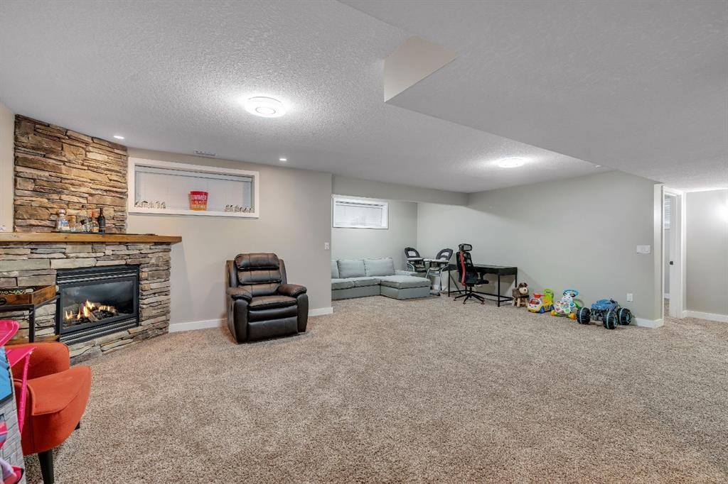 112 Pinto Lane Se, Airdrie, AB - Indoor Photo Showing Basement With Fireplace