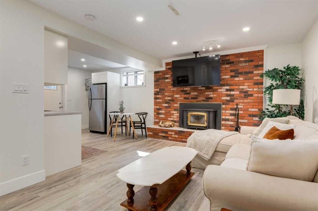 131 Thorncrest Road Nw, Calgary, AB - Indoor Photo Showing Living Room With Fireplace