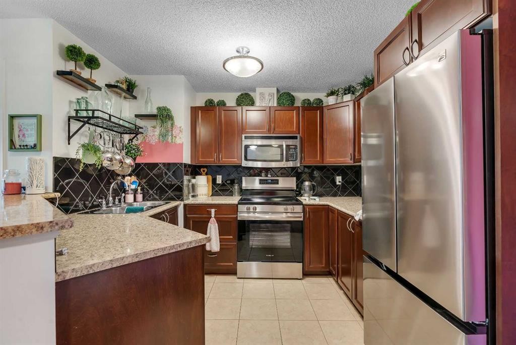 116-428 Chaparral Ravine View Se, Calgary, AB - Indoor Photo Showing Kitchen With Stainless Steel Kitchen With Double Sink