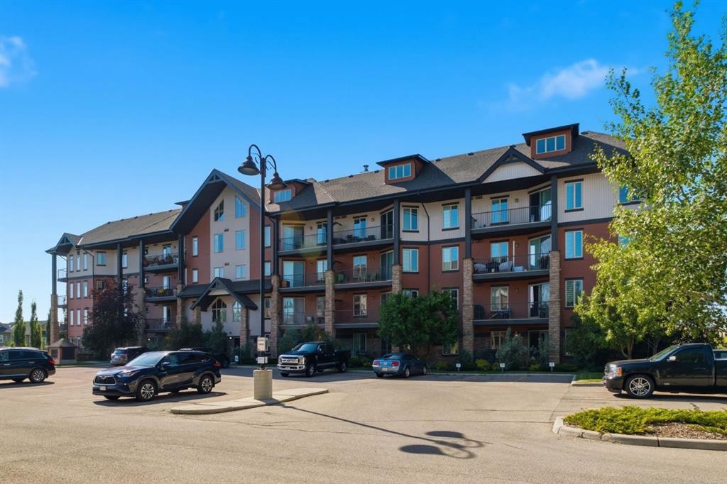 2208-15 Sunset Square, Cochrane, AB - Outdoor With Balcony With Facade