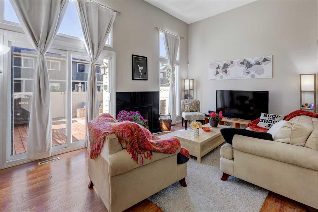 738 Queenston Terrace Se, Calgary, AB - Indoor Photo Showing Living Room With Fireplace